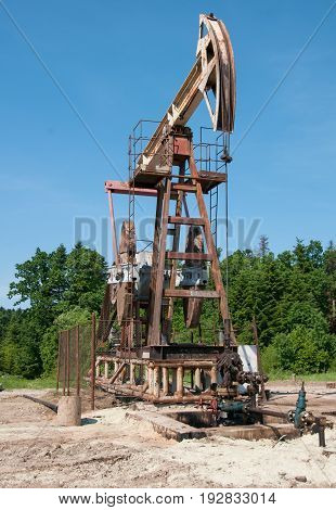 an oil pump is on a background mountains