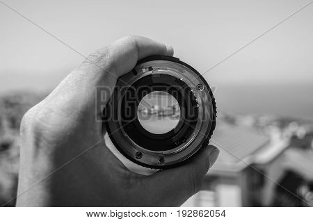 a nikon 50mm lens in front of a landscape