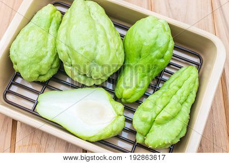 Fresh Chayote fruit on wooden table background