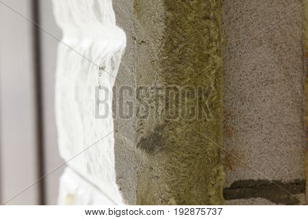 Thermal insulation of a house wall on a building site