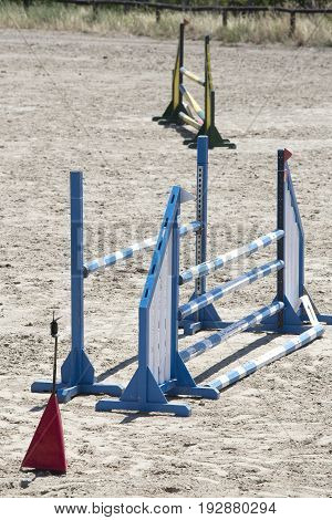 Show jumping barriers on the ground waiting for riders and horses