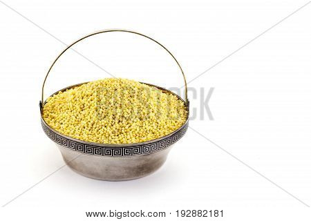 Dry raw Millet in rare silver pial isolated on white background