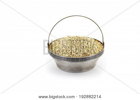 Raw dry Barley in sulver bowl isolated on white