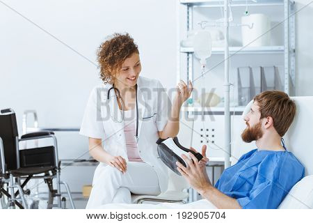 Female doctor explaining VR to young male handsome patient