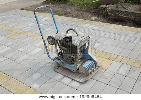 Concrete brick pavement finishing with vibratory plate compactor