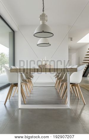 Minimalistic dining zone in open space of big modern house