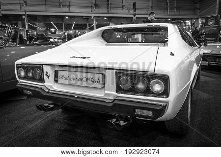 MAASTRICHT NETHERLANDS - JANUARY 14 2016: Sports car Ferrari 308 GT4 Dino 1977. Rear view. Black and white. International Exhibition InterClassics & Topmobiel 2016
