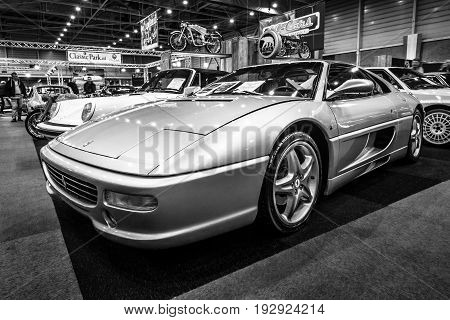 MAASTRICHT NETHERLANDS - JANUARY 14 2016: Sports car Ferrari F355 GTS 1998. Blacl and white. International Exhibition InterClassics & Topmobiel 2016
