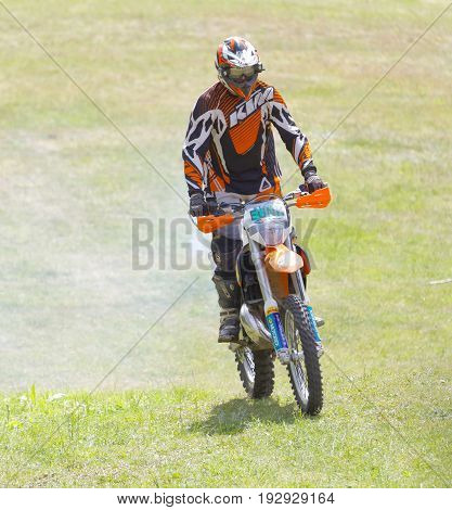 STOCKHOLM SWEDEN - JUNE 11 2017: Official on motorcycle on the meadow at Lida Loop Mountain bike Race. June 11 2017 in Stockholm Sweden