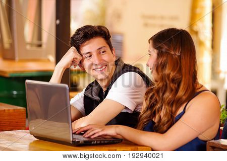 Smiling happy couple at the bar spending time together.