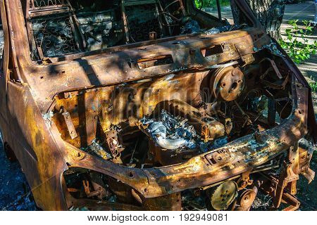 Burnt after fire rusty abandoned car minibus