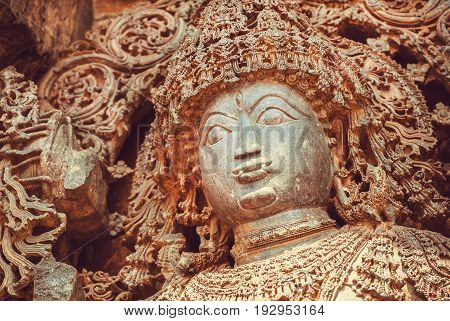 Face of Shiva Lord sculpture on wall of old relief. 12th centur Hindu Hoysaleshwara temple in Halebidu, India.