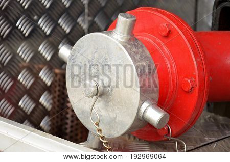 Firefighting equipment on red fire truck. Water hydrant closeup photo with selective focus