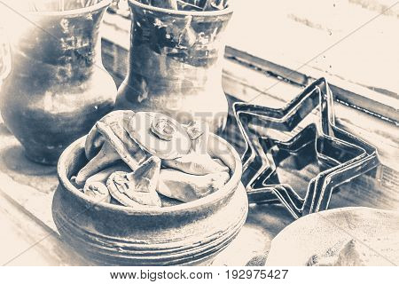 windowsill. many small pottery lying on the plate closeup. Creative studio potter. Workplace wizard Crock pottery