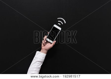 Hand Of Woman Holding Smartphone With Blank Screen Isolated On Black