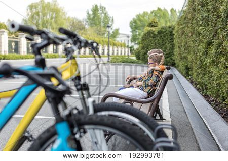 Little Kids Embrasing While Sitting On Bench At Park