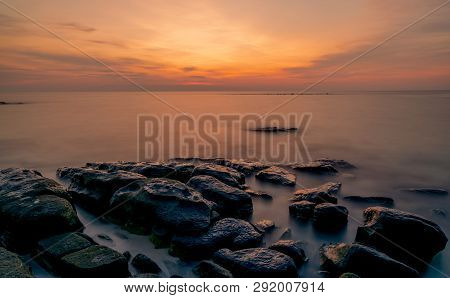 Rocks On Stone Beach At Sunset. Beautiful Beach Sunset Sky. Twilight Sea And Sky. Tropical Sea At Du