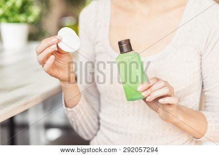 Makeup Remove Skin Care. Closeup Woman Holding Cotton Swab And Makeup Remover Liquid Cosmetic In Han