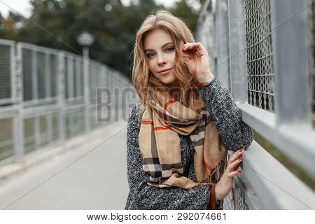Beautiful Cute Young Woman With Blond Hair In An Elegant Coat With A Stylish Beige Scarf Posing On A
