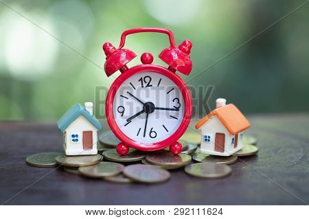 Mini House On Stack Of Coins,money And House,  Mortgage, Savings Money For Buy House And Loan To Bus