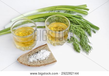 Pepper Vodka In Two Transparent Glasses, Green Onions, Dill, Rye Bread And Coarse Salt - Still Life.