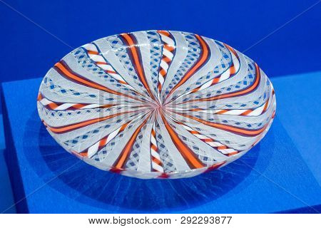 Colorful Handmade Plate With Red Ornament On Blue Table Close-up Vintage