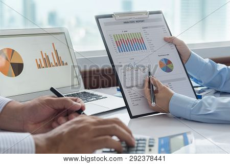 Businessmen Are Analyzing Data From Business Report And Marketing Team Brainstorming Process To Data