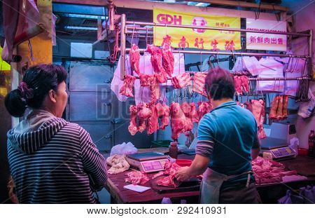 Hong Kong, Dec. 2013: Streetside Butchers Cut Up Pork For Sale At Fa Yuen Street Market In Mong Kok