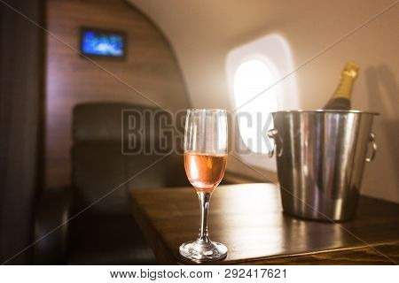 A Glass Of Champagne In The Interior Of A Private Jet. Flying First Class