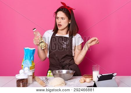 Charming Young Lady Making Bakery In Kitchen, Uses Many Ingredients And Utensils For Kneading Dough,