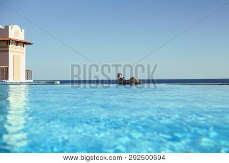 Young Woman Feel Freedom And Enjoying Relaxationin Infinity Pool , Travel And Leisure, Vacation Retr
