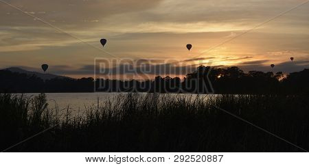 Hot Air Balloons Flying In The Air Above Lake Burley Griffin, As Part Of The Balloon Spectacular Fes