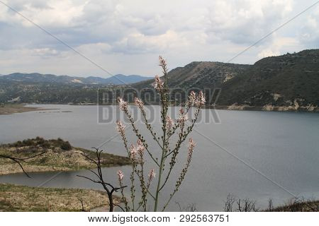 Panoramic View Of Kouris Water Reservoir In Cyprus And The Mountains Around On A Cloudy Spring Day