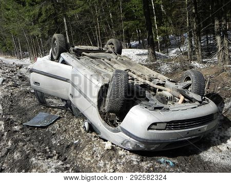 Car Accident, Overturned Car. The Accident Happened In The Winter On A Slippery Road. The Car Is On 