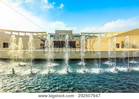 Fountains With Katara Amphitheater At Classical Greek Theater In Blurred Background. Katara Village 