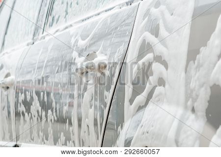 Car Wash With Foam In Car Wash Station. Carwash. Washing Machine At The Station. Car Washing Concept