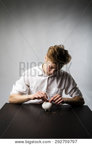Young Man And Piggy Bank. Financial Security Planning Concept.