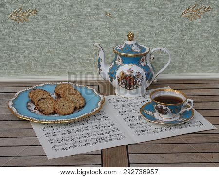 English Teacup With Saucer, Teapot And A Cake Plate With Cookies, Fine Bone China Porcelain, On Musi