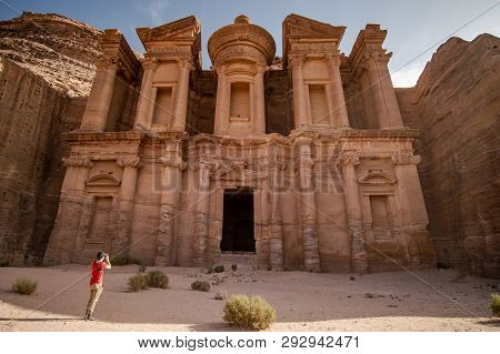 Young Asian Man Traveler And Photographer Taking Photo At Ad Deir Or El Deir, The Monument Carved Ou