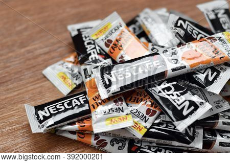 Many Nescafe Caramel Cream Coffee Sticks On Wooden Background. Nescafe Is A Brand Of Coffee Made By 