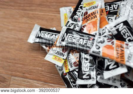 Many Nescafe Caramel Cream Coffee Sticks On Wooden Background. Nescafe Is A Brand Of Coffee Made By 