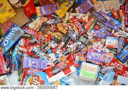 Many Wrappings And Cans From Used Products By Famous Worldwide Brands. Pattern Of Trash Of Various C