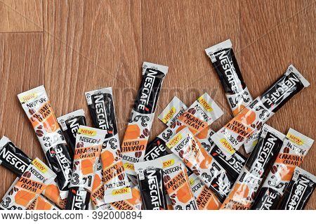 Many Nescafe Caramel Cream Coffee Sticks On Wooden Background. Nescafe Is A Brand Of Coffee Made By 