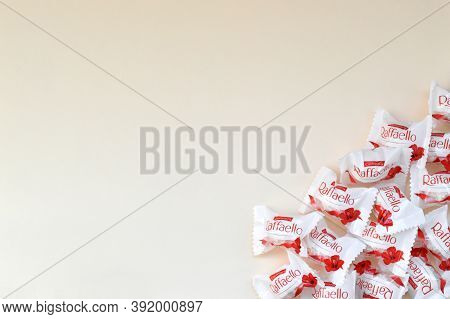 Raffaello Candies On Beige Background. Raffaello Is A Spherical Coconut Almond Confection That Itali