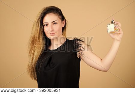 Share The Secret. Pretty Woman Hold Perfume. Perfumery Shop. Woman With Bottle Of Perfume. Girl Appl