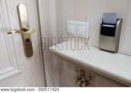 Closeup View Of A Security Key Card Near The Entrance Door That Controls Power In A Hotel Room. Inse