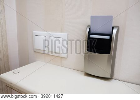 Closeup View Of A Security Key Card That Controls Power In A Hotel Room. Inserting Cardkey For Acces