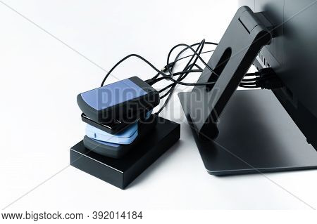 Multiple External Hard Drives Connected To A Monoblock On A White Background.computer With Hard Driv