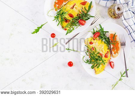 Omelette With Tomatoes, Cheese, Ham And Sandwich Wich Red Cavier On Plate.  Frittata - Italian Omele