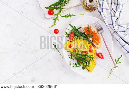 Omelette With Tomatoes, Cheese, Ham And Sandwich Wich Red Cavier On Plate.  Frittata - Italian Omele